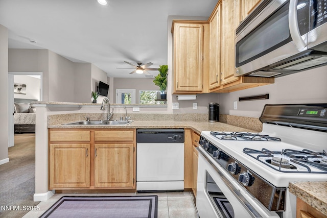 900 S Meadows Pkwy Unit 2623, Reno, NV 89521 - kitchen featuring white range with gas stovetop, dishwasher, stainless steel microwave, a sink, and light brown cabinets