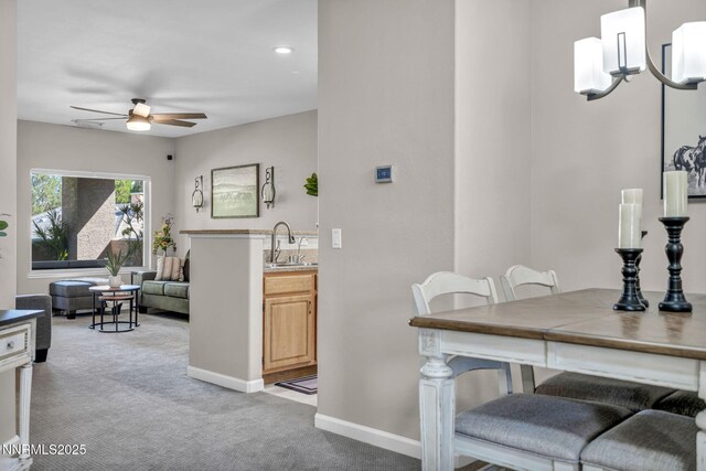 900 S Meadows Pkwy Unit 2623, Reno, NV 89521 - dining space with light carpet, a ceiling fan, and baseboards