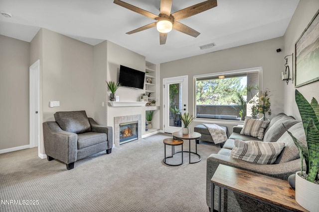 900 S Meadows Pkwy Unit 2623, Reno, NV 89521 - carpeted living room featuring a tile fireplace, built in shelves, a ceiling fan, and baseboards