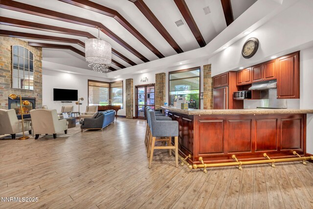 900 S Meadows Pkwy Unit 2623, Reno, NV 89521 - kitchen featuring built in fridge, plenty of natural light, stainless steel microwave, decorative light fixtures, and beamed ceiling