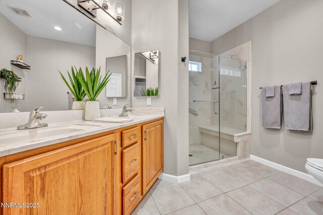900 S Meadows Pkwy Unit 2623, Reno, NV 89521 - bathroom with a shower stall, double vanity, tile patterned floors, and toilet