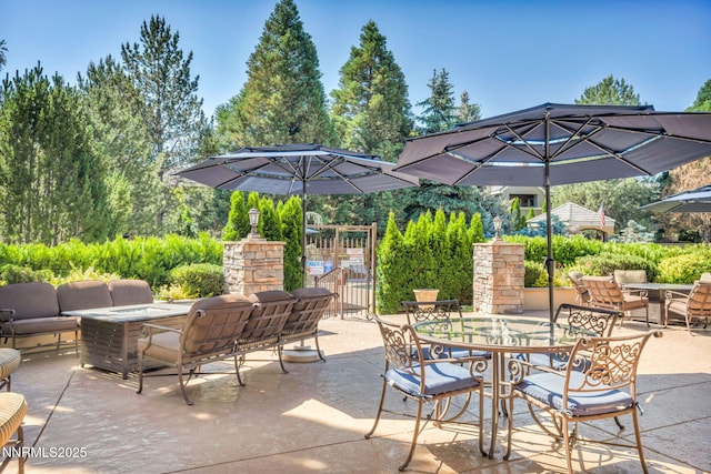 900 S Meadows Pkwy Unit 2623, Reno, NV 89521 - view of patio featuring an outdoor living space with a fire pit, outdoor dining area, and a gate