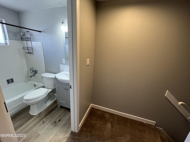 1140 S Curry St, Carson City, NV 89703 - full bathroom with toilet, vanity, wood finished floors, washtub / shower combination, and baseboards