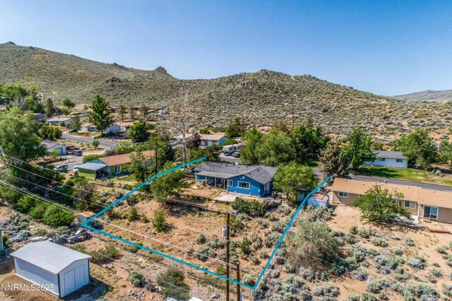 8725 Paloma Way, Reno, NV 89506 - aerial perspective of suburban area with property boundaries highlighted and a mountain backdrop