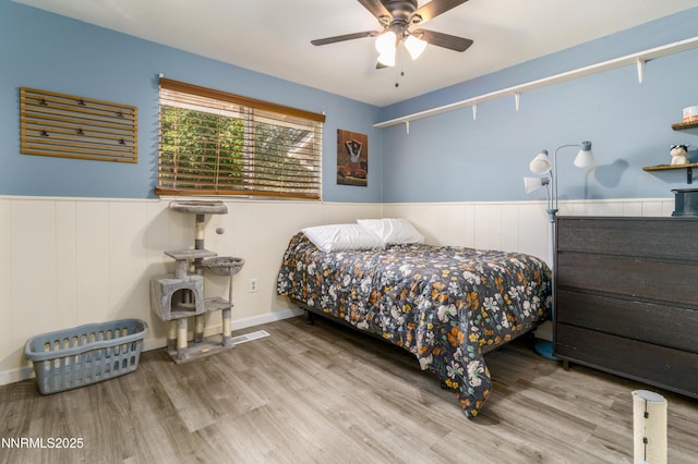 8725 Paloma Way, Reno, NV 89506 - bedroom with wainscoting, wood finished floors, and ceiling fan