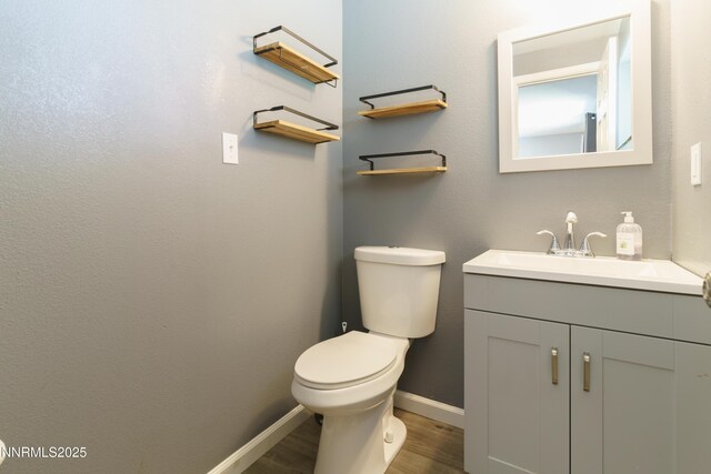 8725 Paloma Way, Reno, NV 89506 - bathroom with wood finished floors, vanity, toilet, and baseboards