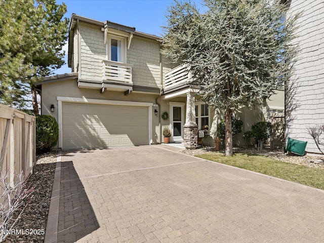 7693 Stone Bluff Way, Reno, NV 89523 - view of front facade featuring a balcony, stucco siding, a garage, and decorative driveway