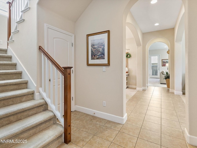 7693 Stone Bluff Way, Reno, NV 89523 - foyer featuring light tile patterned floors, arched walkways, stairs, recessed lighting, and baseboards