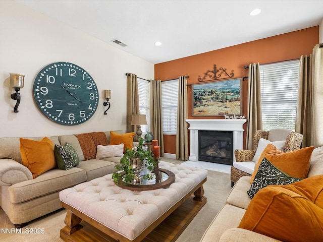 7693 Stone Bluff Way, Reno, NV 89523 - living room with light colored carpet, plenty of natural light, a glass covered fireplace, and recessed lighting
