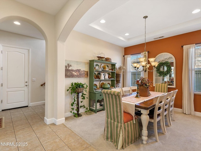 7693 Stone Bluff Way, Reno, NV 89523 - dining space featuring arched walkways, recessed lighting, a chandelier, baseboards, and light colored carpet