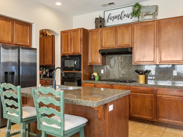 7693 Stone Bluff Way, Reno, NV 89523 - kitchen with black appliances, under cabinet range hood, backsplash, and recessed lighting
