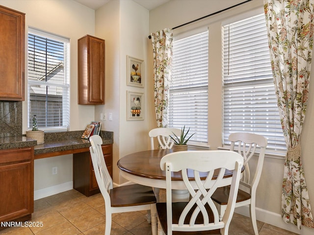 7693 Stone Bluff Way, Reno, NV 89523 - dining space with baseboards, light tile patterned floors, and built in study area