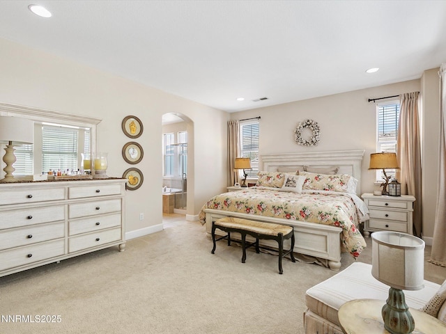 7693 Stone Bluff Way, Reno, NV 89523 - bedroom with arched walkways, light colored carpet, recessed lighting, baseboards, and connected bathroom