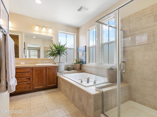 7693 Stone Bluff Way, Reno, NV 89523 - full bathroom featuring vanity, a garden tub, tile patterned flooring, and a stall shower