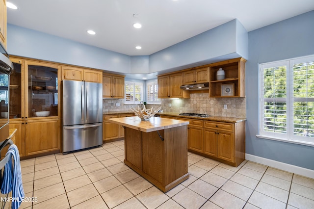 1314 Saint Gallen Ct, Incline Village, NV 89451 - kitchen featuring appliances with stainless steel finishes, under cabinet range hood, light tile patterned floors, backsplash, and recessed lighting