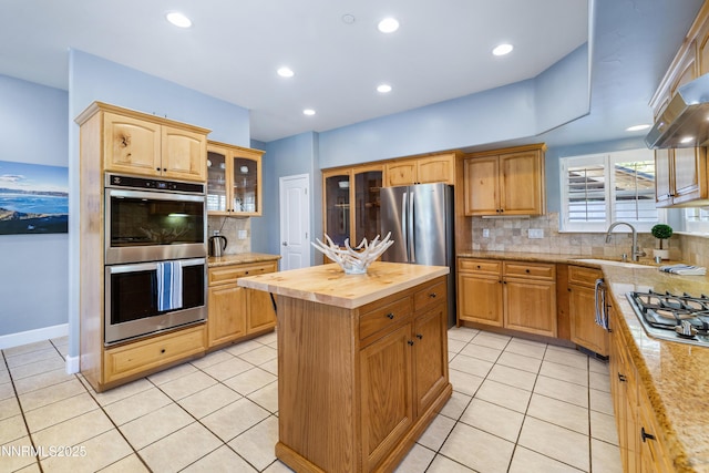 1314 Saint Gallen Ct, Incline Village, NV 89451 - kitchen featuring appliances with stainless steel finishes, a sink, butcher block counters, decorative backsplash, and glass insert cabinets