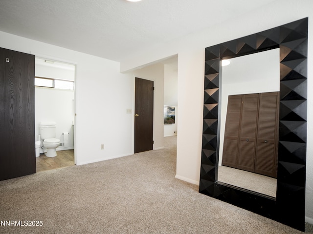 5026 Snowy Mountain Dr, Winnemucca, NV 89445 - unfurnished bedroom featuring carpet floors, a closet, ensuite bath, and baseboards