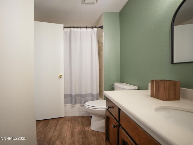 5026 Snowy Mountain Dr, Winnemucca, NV 89445 - bathroom with toilet, vanity, wood finished floors, and shower / tub combo