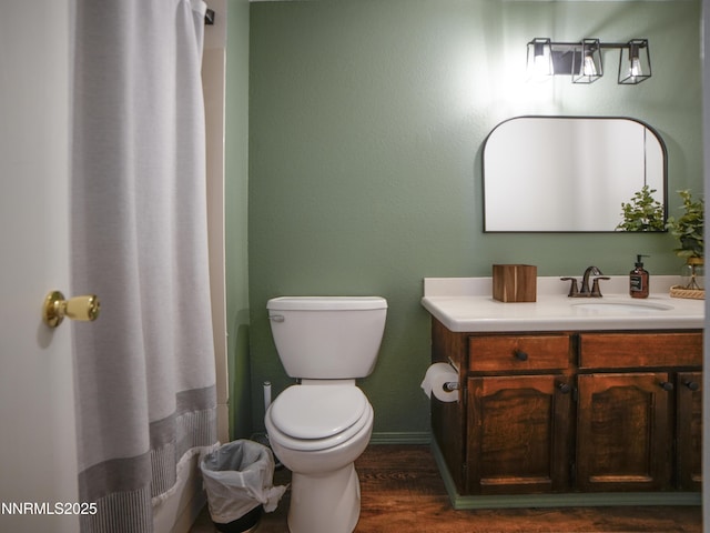 5026 Snowy Mountain Dr, Winnemucca, NV 89445 - full bathroom featuring vanity, toilet, wood finished floors, and baseboards