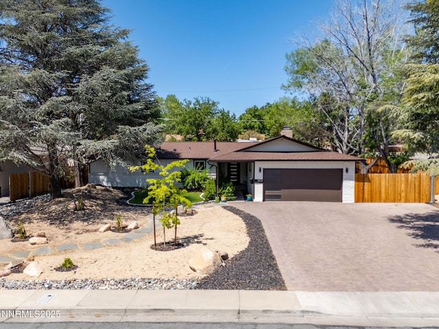 1901 S Marsh Ave, Reno, NV 89509 - ranch-style home featuring a garage, decorative driveway, and a chimney