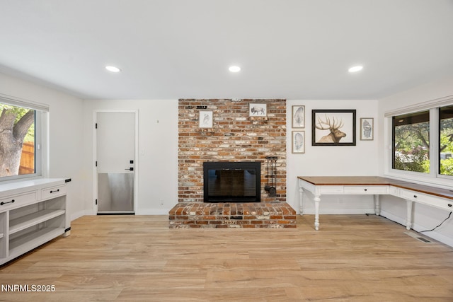 1901 S Marsh Ave, Reno, NV 89509 - unfurnished living room with light wood-style floors, a brick fireplace, baseboards, and recessed lighting