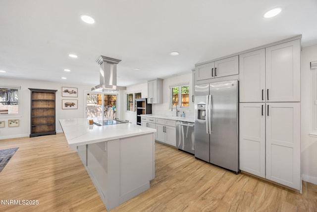 1901 S Marsh Ave, Reno, NV 89509 - kitchen featuring stainless steel appliances, island exhaust hood, light countertops, a kitchen island, and recessed lighting