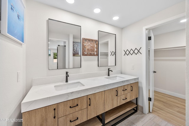 1901 S Marsh Ave, Reno, NV 89509 - bathroom with double vanity, a spacious closet, baseboards, and recessed lighting