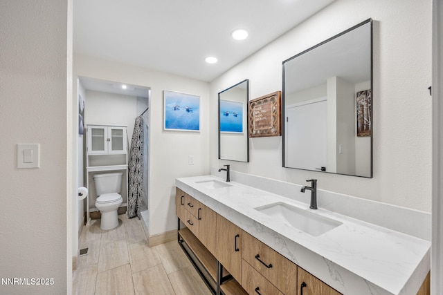 1901 S Marsh Ave, Reno, NV 89509 - bathroom with toilet, double vanity, recessed lighting, baseboards, and curtained shower