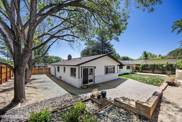1901 S Marsh Ave, Reno, NV 89509 - rear view of property with a chimney, a patio, a fenced backyard, roof with shingles, and brick siding
