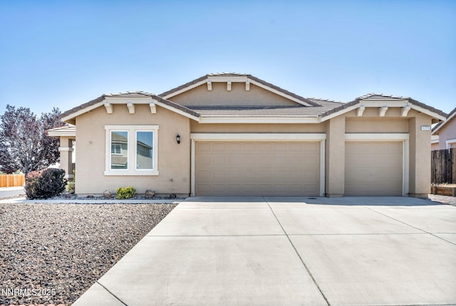 1771 Walnut Dr, Fernley, NV 89408 - view of front of home featuring a garage, stucco siding, driveway, and a tiled roof