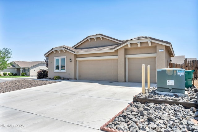 1771 Walnut Dr, Fernley, NV 89408 - view of front of home featuring an attached garage, stucco siding, driveway, and a tile roof