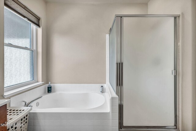 1771 Walnut Dr, Fernley, NV 89408 - bathroom with healthy amount of natural light, a shower stall, and a garden tub