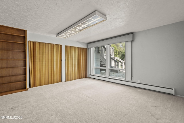 1405 Dartmouth Dr, Reno, NV 89509 - empty room featuring baseboard heating, a textured ceiling, and carpet