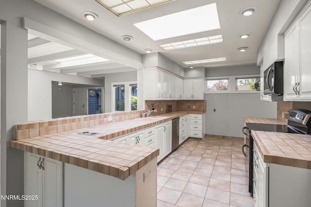 1405 Dartmouth Dr, Reno, NV 89509 - kitchen featuring tile counters, range with electric stovetop, tasteful backsplash, and recessed lighting