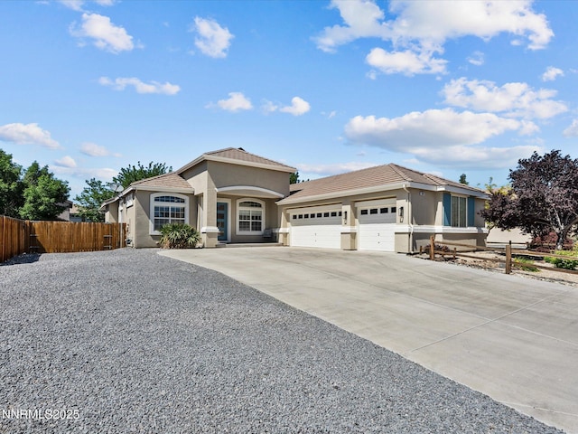 2814 S Fork Rd, Fernley, NV 89408 - view of front of house featuring concrete driveway, a garage, stucco siding, and a tile roof