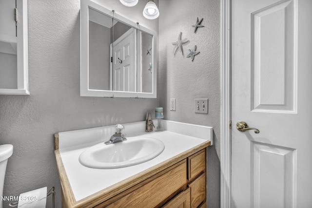 1416 Sally Ln, Gardnerville, NV 89460 - bathroom featuring a textured wall, vanity, and toilet