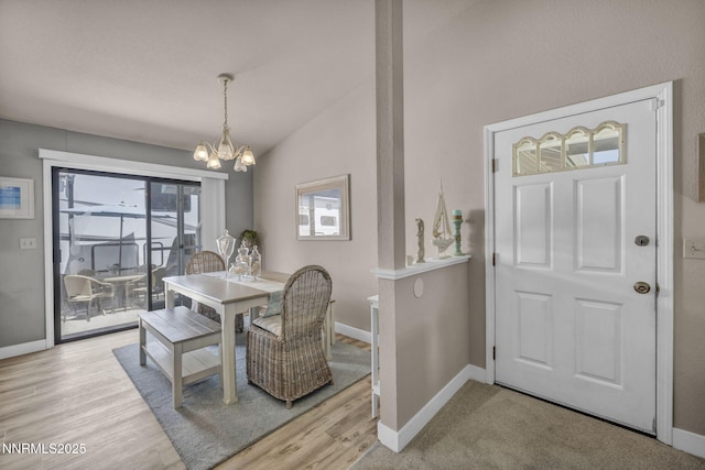 1416 Sally Ln, Gardnerville, NV 89460 - dining room featuring a chandelier, lofted ceiling, baseboards, and light wood-type flooring