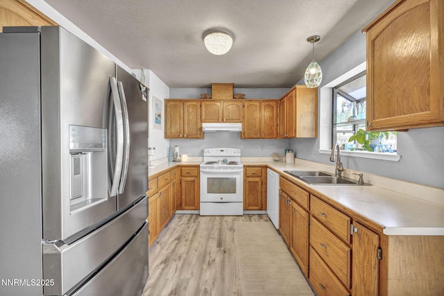 1416 Sally Ln, Gardnerville, NV 89460 - kitchen with white appliances, a sink, under cabinet range hood, light wood finished floors, and light countertops