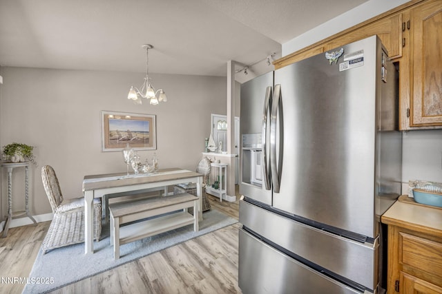 1416 Sally Ln, Gardnerville, NV 89460 - dining area featuring light wood-style floors, a chandelier, and track lighting