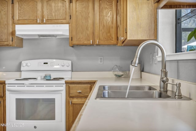 1416 Sally Ln, Gardnerville, NV 89460 - kitchen with electric range, under cabinet range hood, a sink, light countertops, and brown cabinets