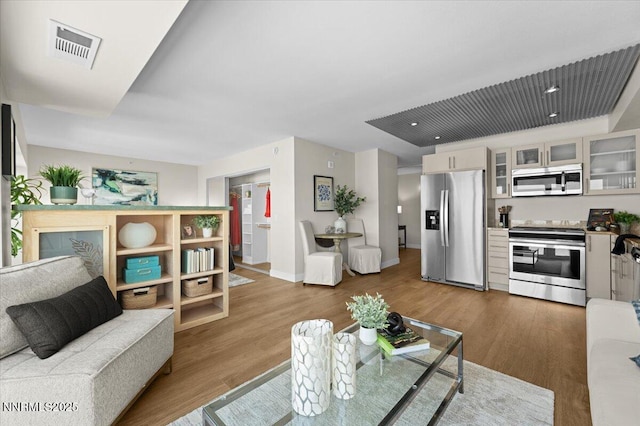 255 N Sierra St Unit 1410, Reno, NV 89501 - living room featuring wood finished floors and baseboards