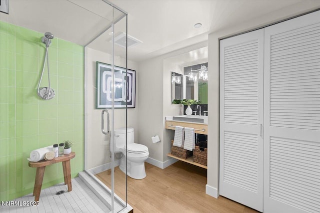 255 N Sierra St Unit 1410, Reno, NV 89501 - bathroom with a closet, a stall shower, toilet, and wood finished floors