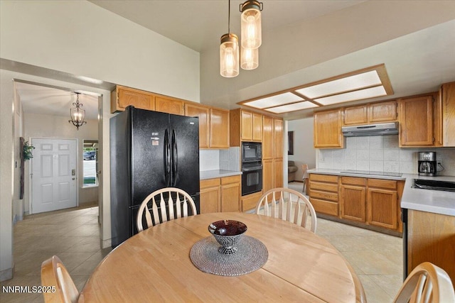 4492 Trenton Ct, Sparks, NV 89436 - kitchen with black appliances, light tile patterned floors, under cabinet range hood, and backsplash