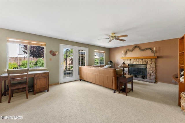 4492 Trenton Ct, Sparks, NV 89436 - living room featuring a ceiling fan, light carpet, and a stone fireplace
