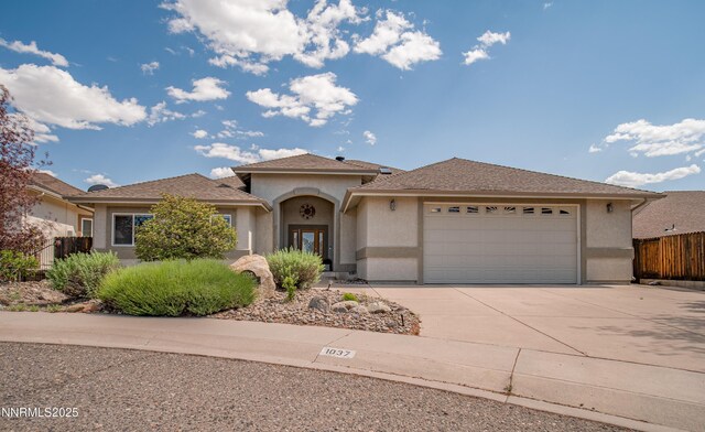 1037 Haystack Dr, Carson City, NV 89705 - view of front of home with stucco siding, concrete driveway, and a garage