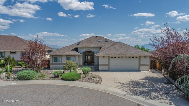 1037 Haystack Dr, Carson City, NV 89705 - view of front of property featuring stucco siding, an attached garage, concrete driveway, and roof with shingles