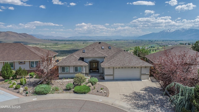 1037 Haystack Dr, Carson City, NV 89705 - view of front of house featuring a mountain view, stucco siding, a garage, and driveway