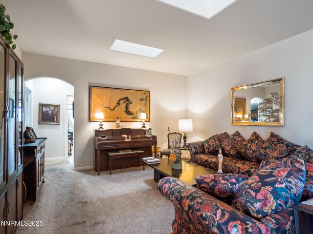 1037 Haystack Dr, Carson City, NV 89705 - living area featuring a skylight, carpet floors, arched walkways, and baseboards