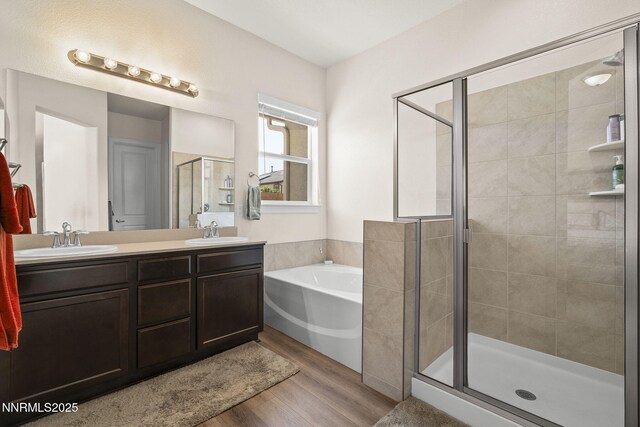 910 Cranfield Ct, Reno, NV 89506 - full bath featuring a shower stall, a bath, wood finished floors, and double vanity
