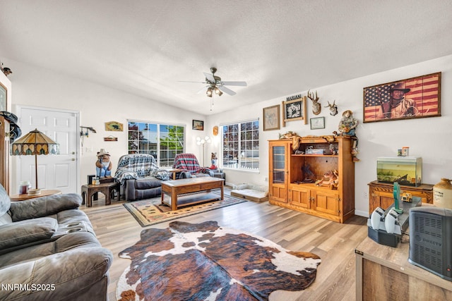 17533 Javalina Ct, Reno, NV 89508 - living room with ceiling fan, light wood-style floors, a textured ceiling, and vaulted ceiling